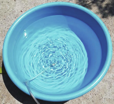 A comparative evaporation reduction method in which an air pump and hose introduced an air bubble plume in the center of the bottom surface of the container.